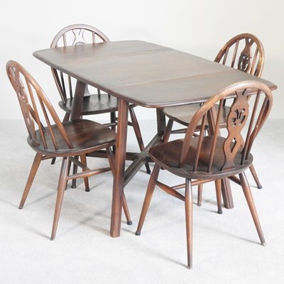 Lot 503 - An Ercol dark elm drop-leaf dining table,...