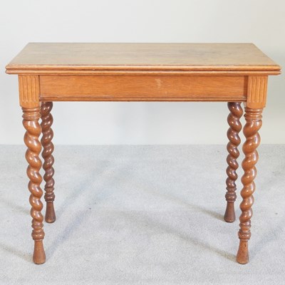 Lot 394 - An early 20th century light oak pull out tea...