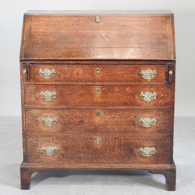 Lot 423 - An 18th century oak bureau, on bracket feet