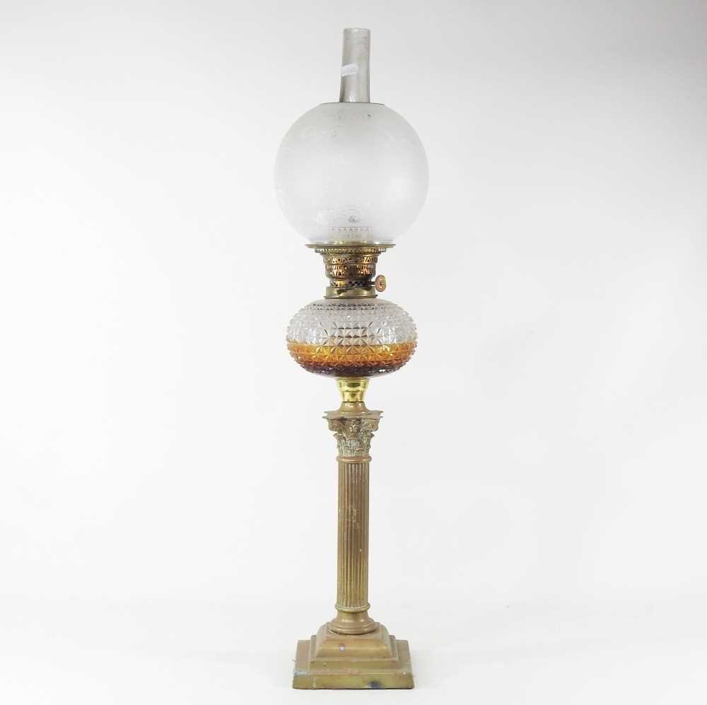 Lot 28 - A 19th century brass oil lamp, in the form of...