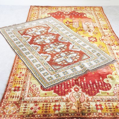 Lot 213 - A Turkish rug with geometric design on a red...