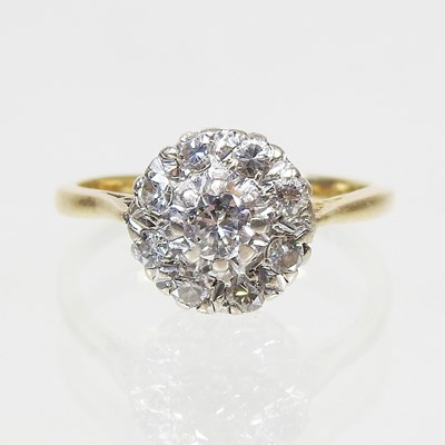 Lot 46 - An 18 carat gold illusion set diamond cluster...