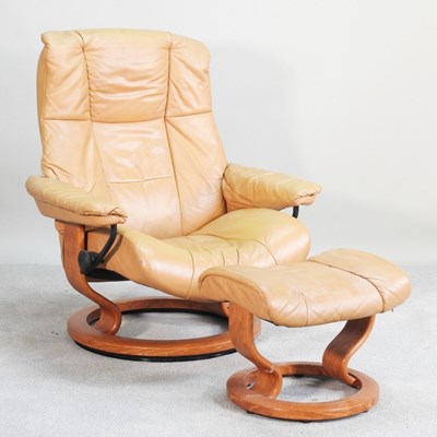Lot 652 - An Ekornes tan upholstered reclining swivel...