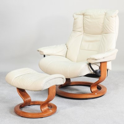Lot 470 - An Ekornes cream upholstered reclining swivel...