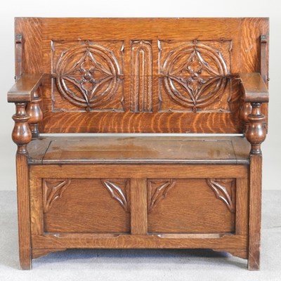 Lot 352 - A 1920s oak monks' bench, with a hinged back
