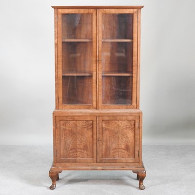 Lot 358 - A 1930s walnut cabinet, with a glazed upper...