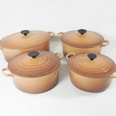 Lot 681 - A set of four Le Creuset cast iron pans, of...