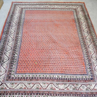 Lot 448 - A Persian rug, having a red ground, within...
