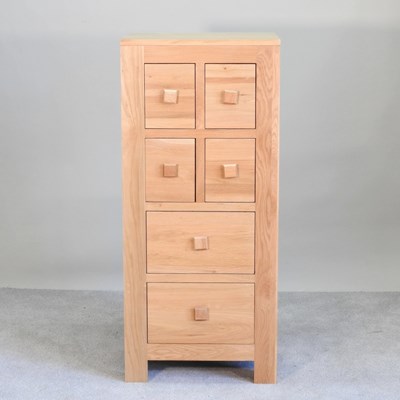 Lot 566 - A modern light oak chest, containing an...