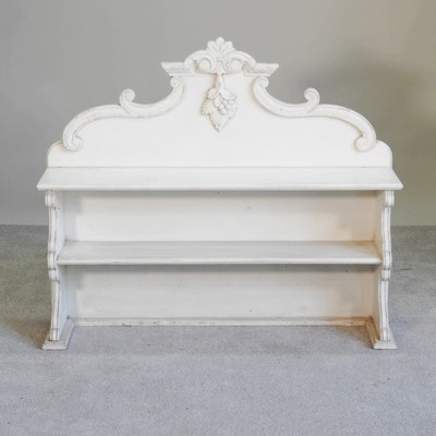 Lot 540 - A cream painted shelf, with a shaped gallery back