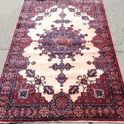 Lot 391 - A Persian rug, with a central medallion, on a...
