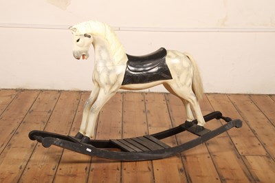 Lot 329 - A carved wooden painted rocking horse