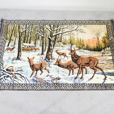 Lot 351 - A woollen tapestry, depicting deer in a snowy...