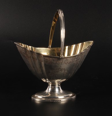 Lot 63 - A George III silver swing-handled sugar basket,...