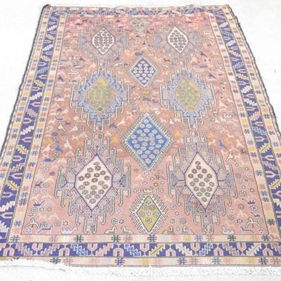 Lot 529 - A Persian rug, with hooked medallions, on a...
