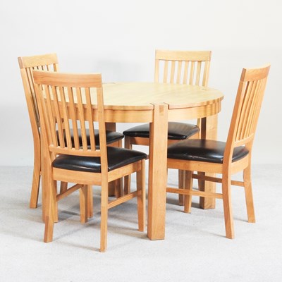Lot 454 - A modern oak circular dining table, together...