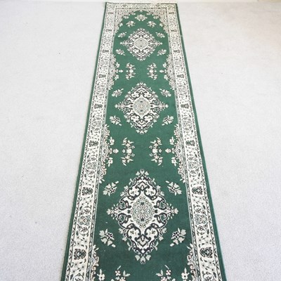 Lot 314 - A modern Persian style runner, on a green...
