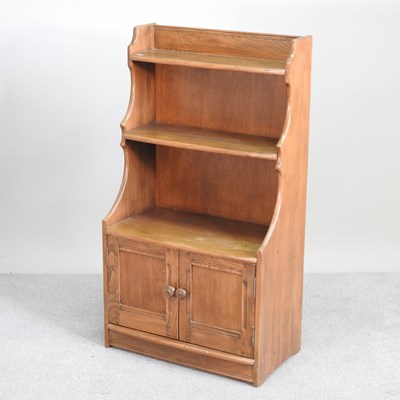 Lot 435 - An Ercol waterfall bookcase, with doors below