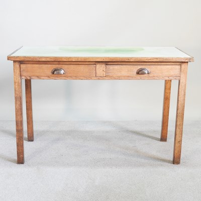 Lot 149 - A mid 20th century light oak writing table,...