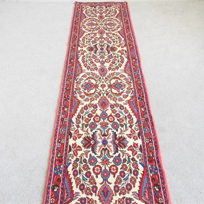 Lot 167 - A Persian runner, with scrolling foliate...