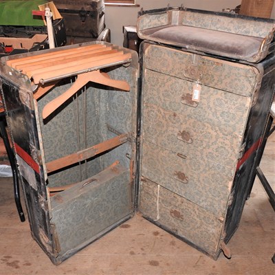 Lot 136 - An early 20th century black and red travelling wardrobe