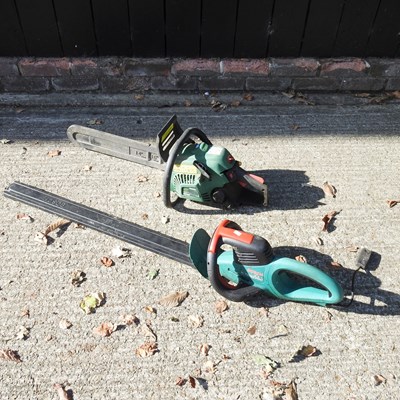Lot 218 - A petrol chainsaw, together with an electric...