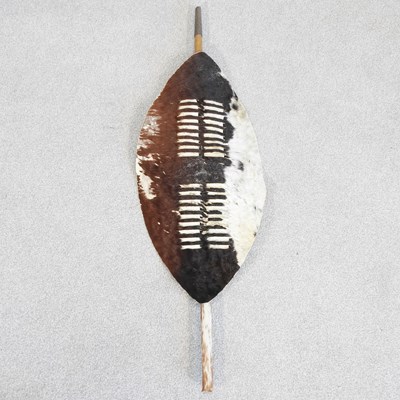 Lot 132 - An African hide tribal shield, 114cm high overall