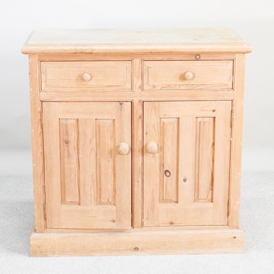 Lot 247 - A modern pine side cabinet, on a plinth base