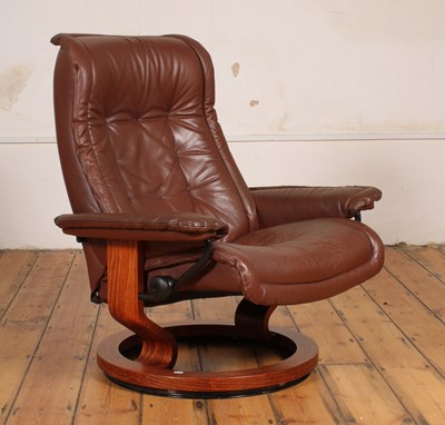 Lot 277 - A Danish brown leather swivel reclining armchair