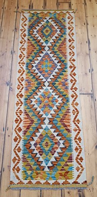 Lot 469 - A Persian kilim runner, with a row of central...