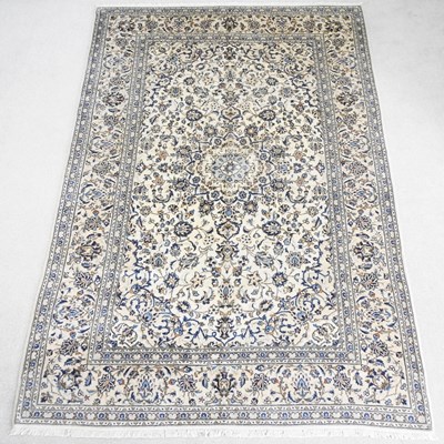 Lot 511 - A Persian Kashan carpet, decorated with...