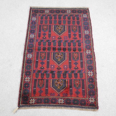 Lot 567 - A baluchi rug, with geometric designs, on a...