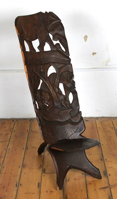 Lot 475 - An African carved birthing stool, relief...