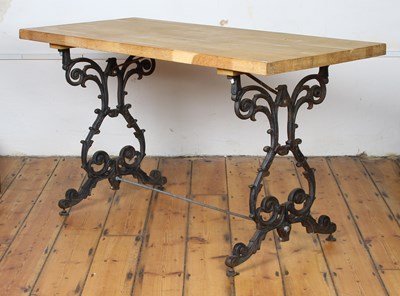 Lot 372 - A light oak table on ornate black painted cast...