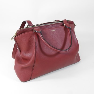 Lot 106 - A Cartier red leather handbag