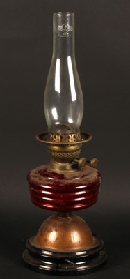 Lot 505 - A Perko oil lamp, with a red glass font, on a...