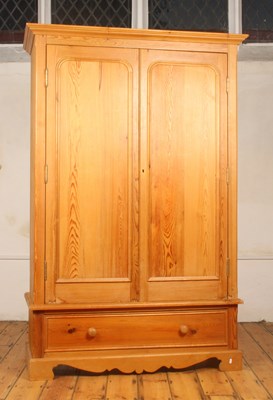 Lot 494 - A pine double wardrobe, having a pair of...