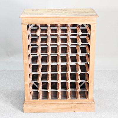 Lot 723 - A small hand made pine wine rack, on a plinth...