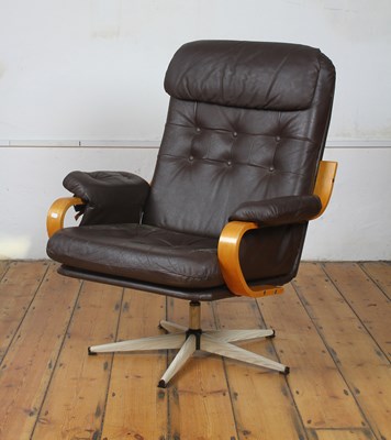 Lot 284 - A vintage Danish dark brown leather swivel...