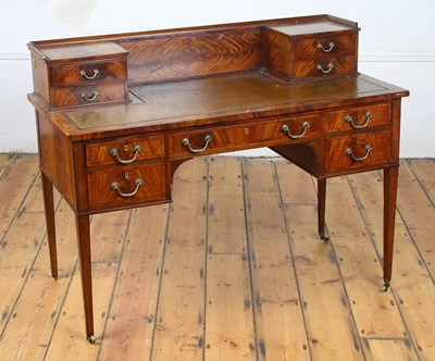 Lot 593 - A Georgian style mahogany leather topped...
