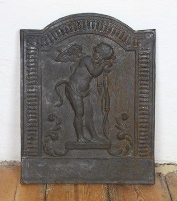 Lot 599 - A cast iron fire back, relief decorated with a...