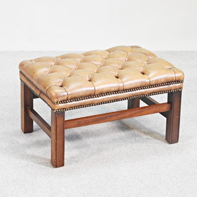 Lot 29 - A leather buttoned footstool, on square...
