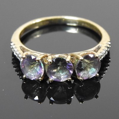 Lot 331 - A 9 carat gold mystic topaz three stone ring,...