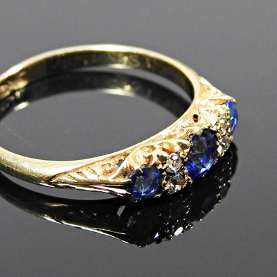 Lot 611 - An 18 carat gold seven stone sapphire and...