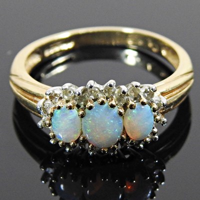 Lot 50 - A 9 carat gold opal and diamond ring triple...