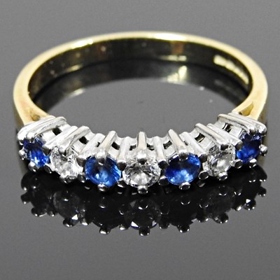 Lot 255 - An 18 carat gold sapphire and diamond seven...