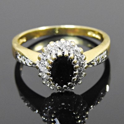 Lot 139 - An 18 carat gold sapphire and diamond cluster...