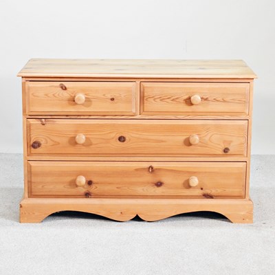 Lot 614 - A modern pine chest of drawers, on a shaped...