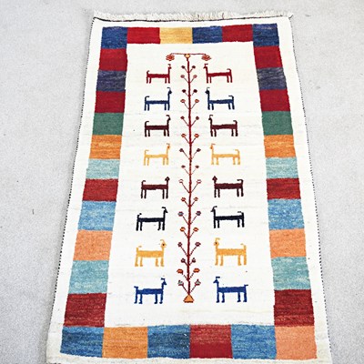 Lot 198 - A Persian Gabeh rug, with a row of animals, on...