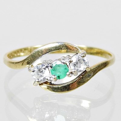Lot 52 - A 9 carat gold emerald and diamond three stone...